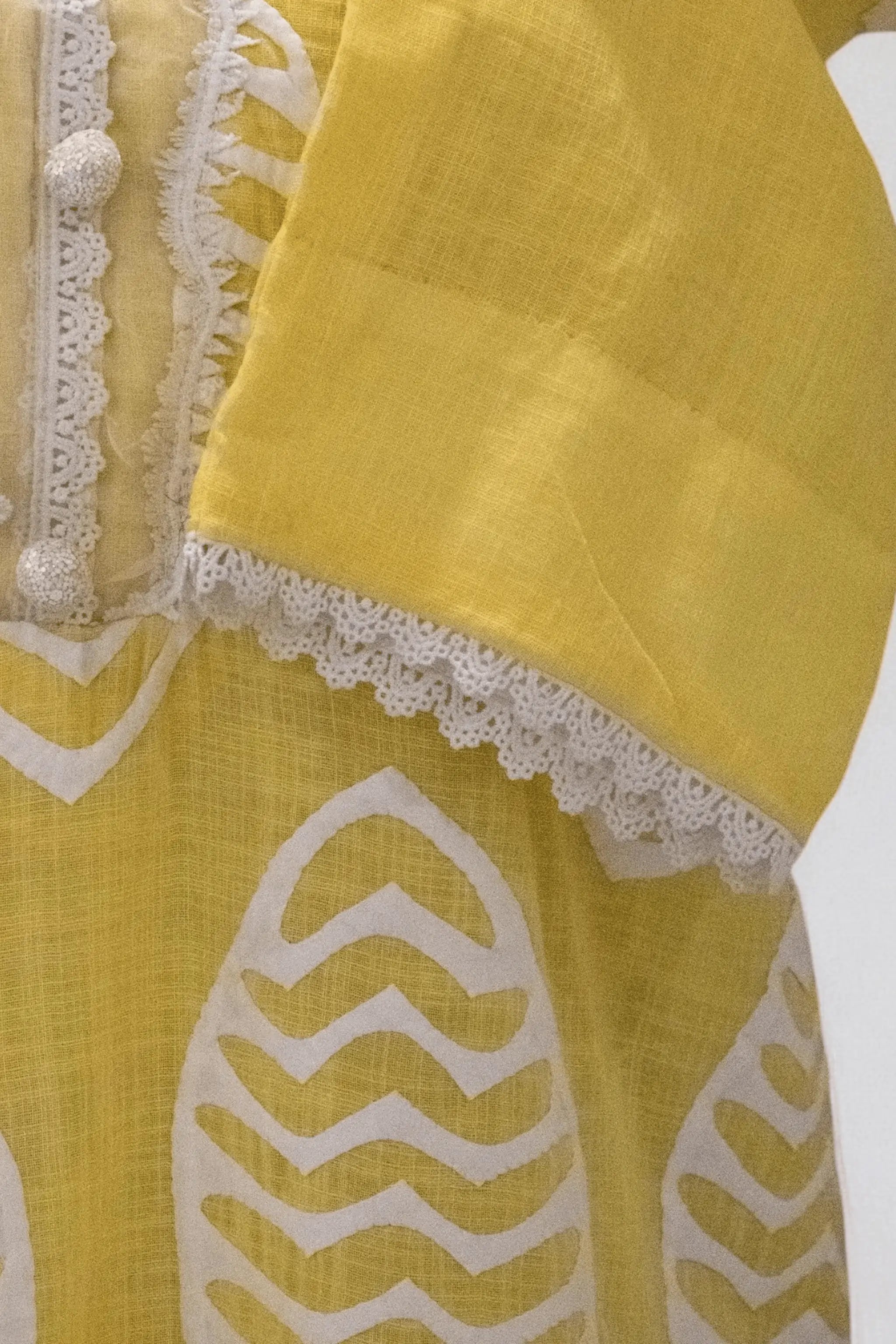 Apachi Bareeze Premium Lawn shirt with white ralli embroidery on yellow base.