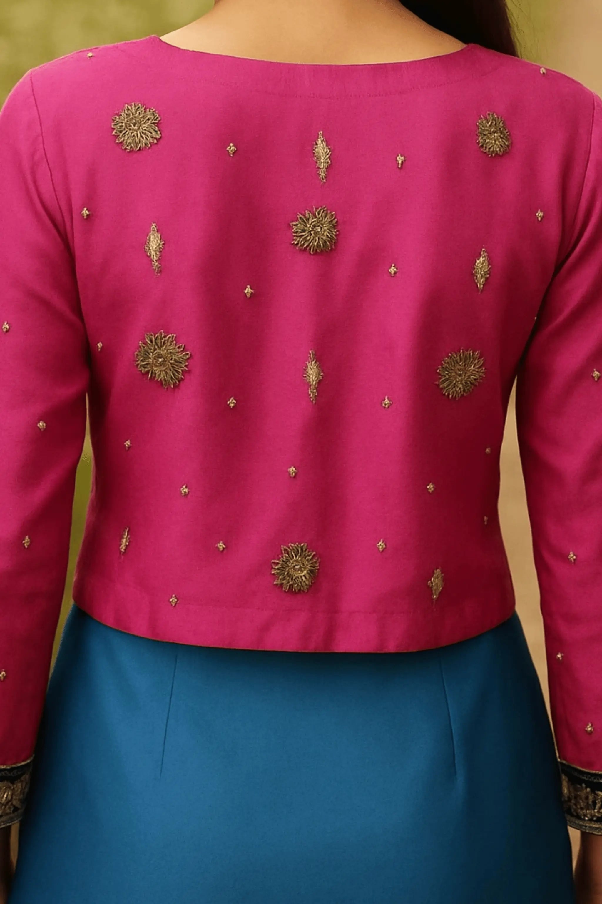 Close-up of Whisper saree blouse with golden and copper embroidery, zardozi, tilla, beads, and sitara on raw silk.