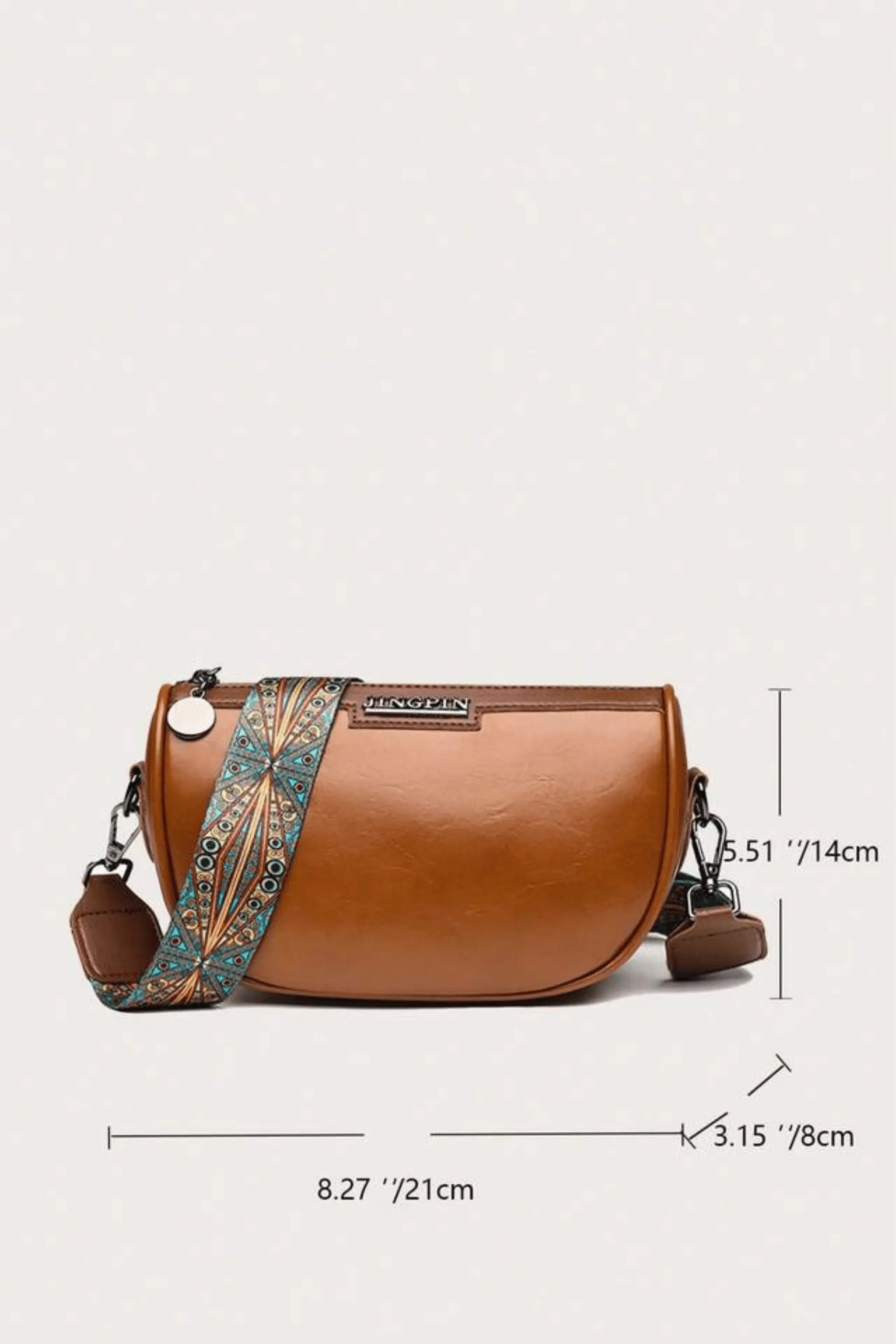 Side view of brown crescent crossbody bag, PU leather handbag with adjustable patterned strap