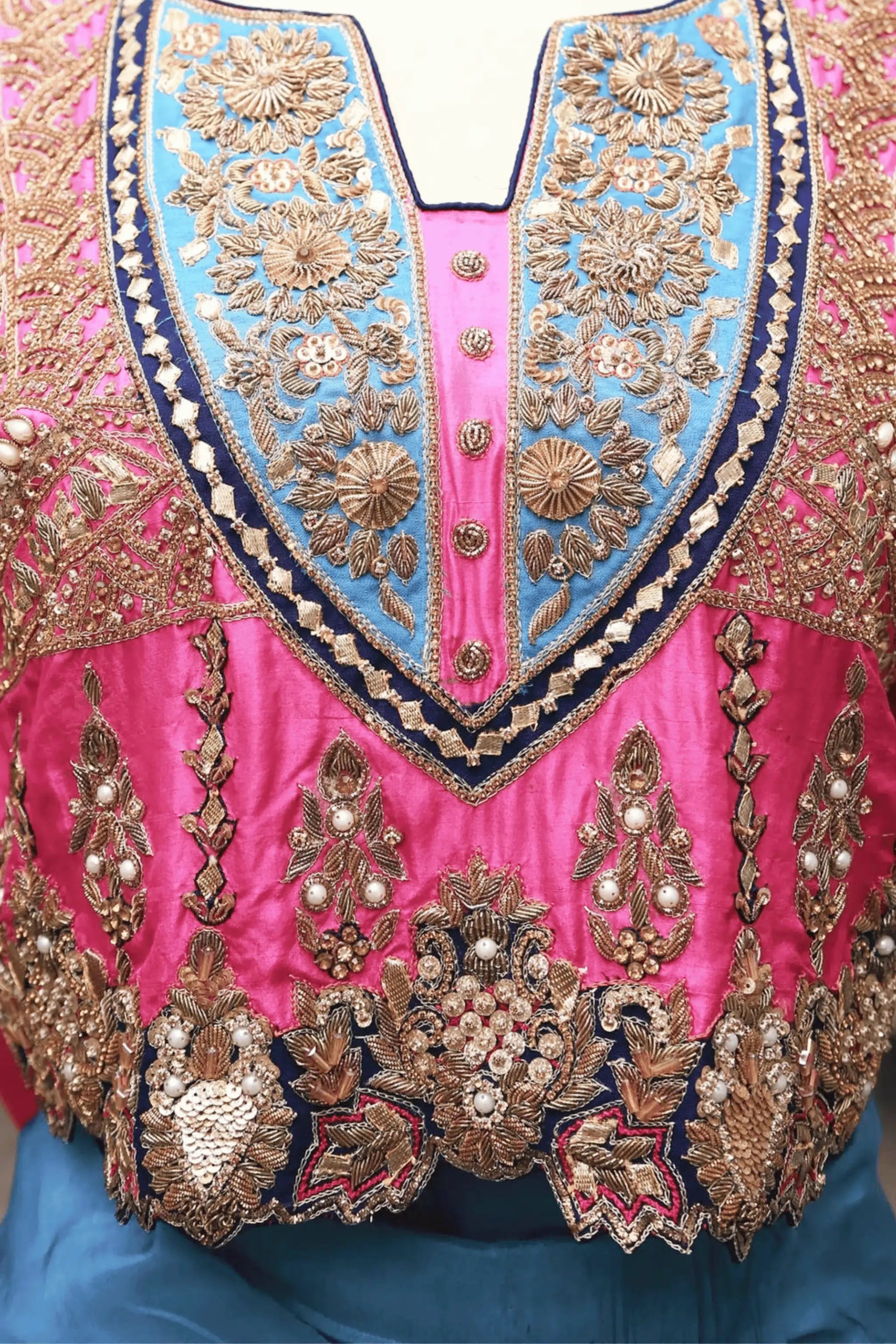 Close-up of Whisper saree blouse with golden and copper embroidery, zardozi, tilla, beads, and sitara on raw silk.