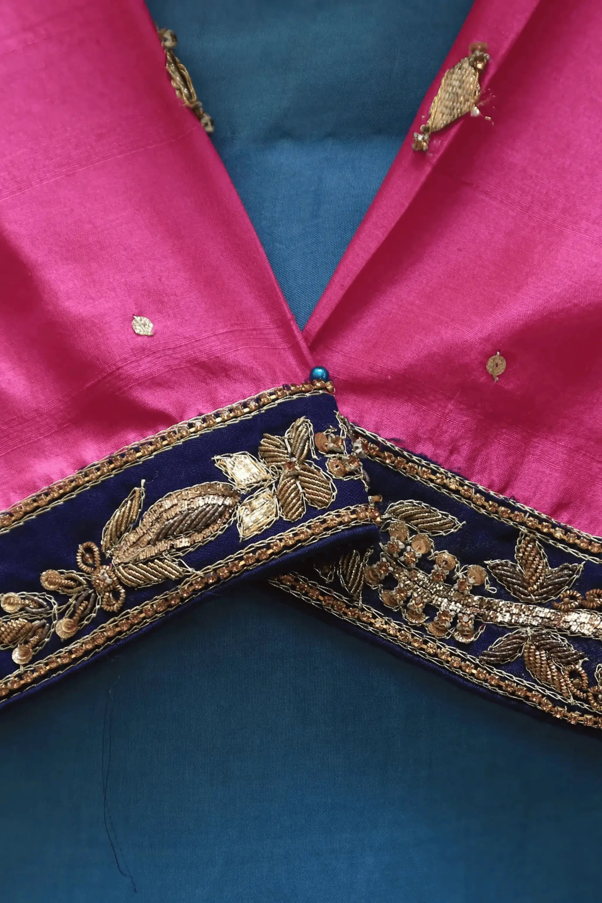 Close-up of Whisper saree blouse with golden and copper embroidery, zardozi, tilla, beads, and sitara on raw silk.