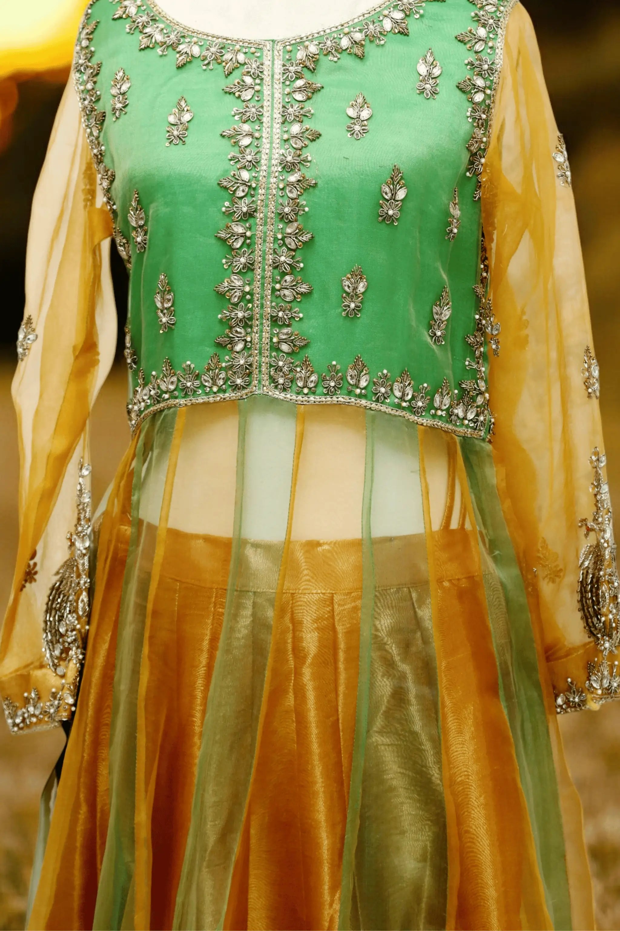 Shamrock three-piece green and gold organza wedding dress with embellished beads and stars work, featuring straight kurta, lehnga, and dupatta — festive bridal wear.