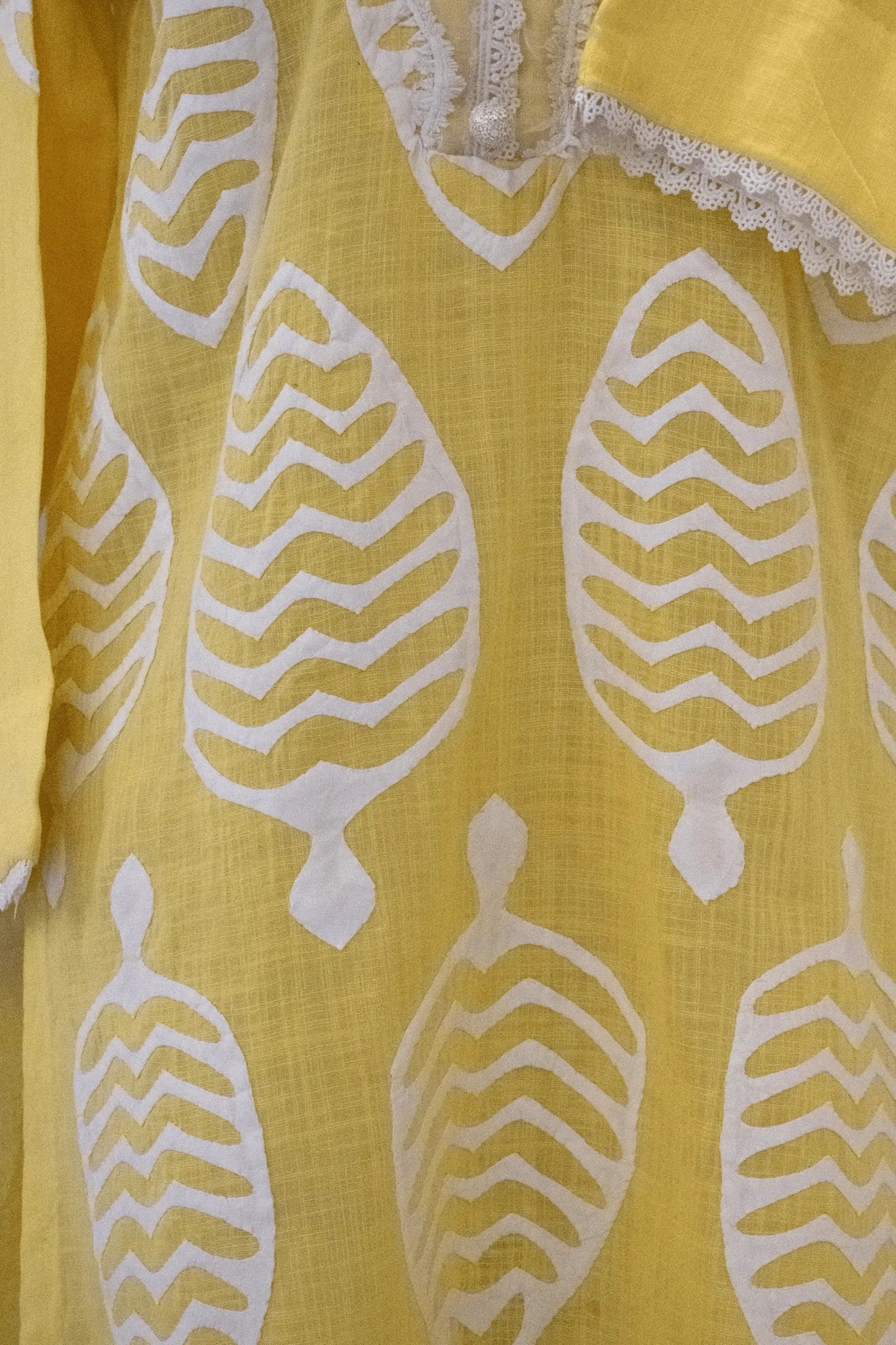 Close-up of Apachi yellow premium lawn shirt with ralli work and lace