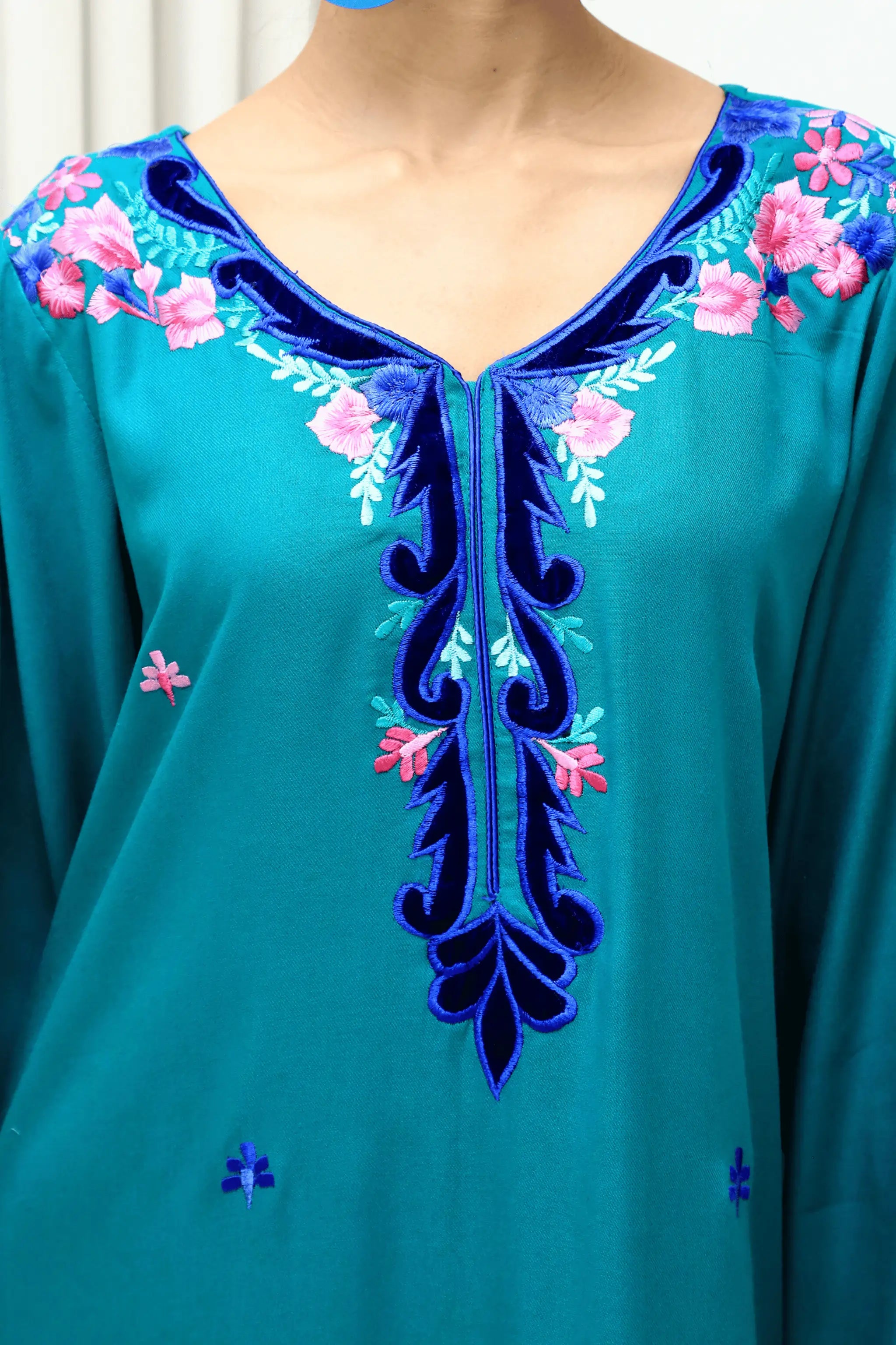 Close-up of Blue Sky neckline embroidery with velvet applique detailing