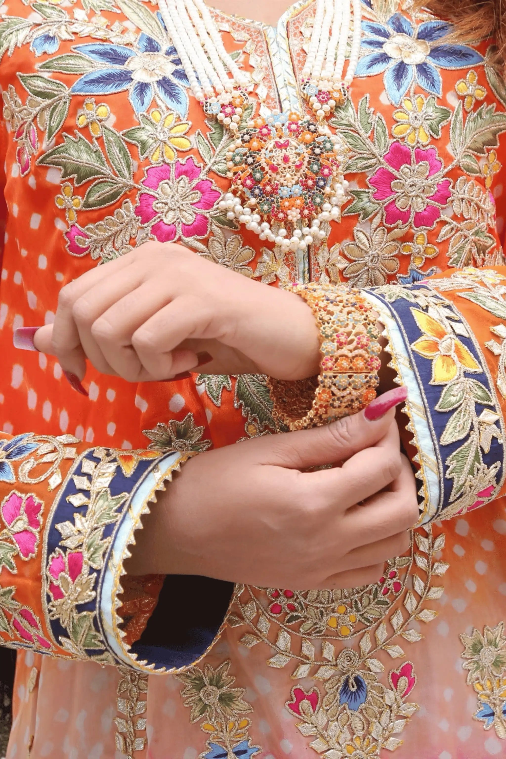 “Close-up of gota patti, star motifs and bead accents on Mirage shirt.”