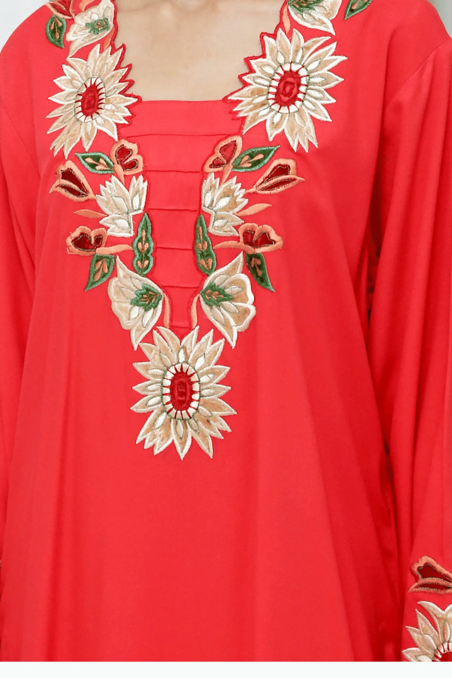 Close-up of neckline embroidery with sunflower motifs