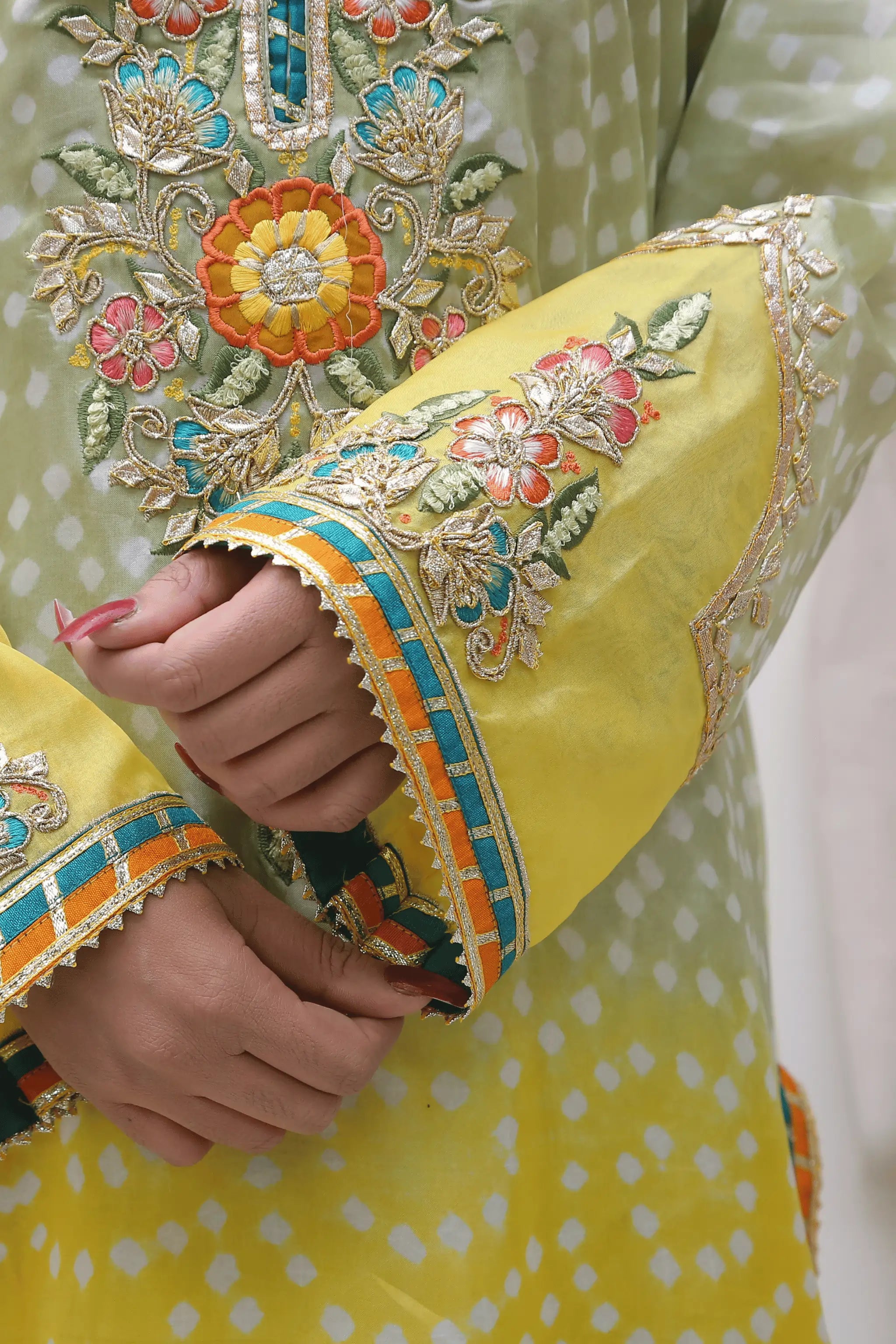 Close-up of thread embroidery with beads and gotta work.