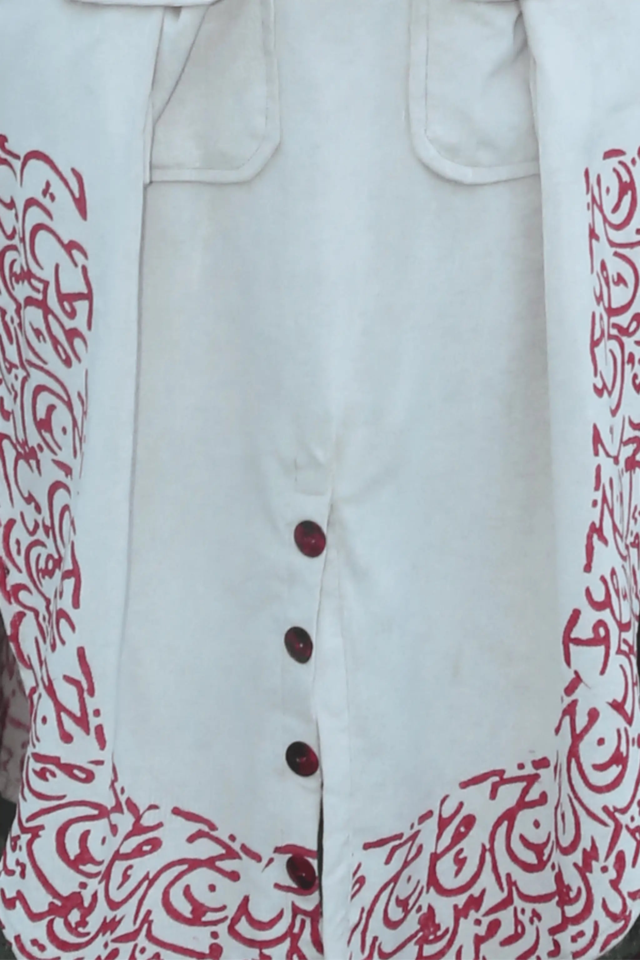 Decorative button detail with calligraphy accents