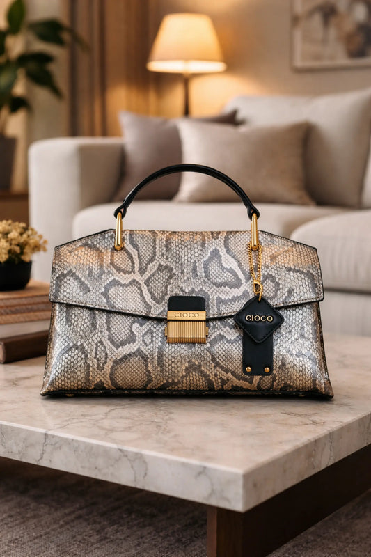 Vintage blue snakeskin-textured luxury handbag with structured square design, flap closure and top handle, displayed as a high-end women’s fashion accessory.
